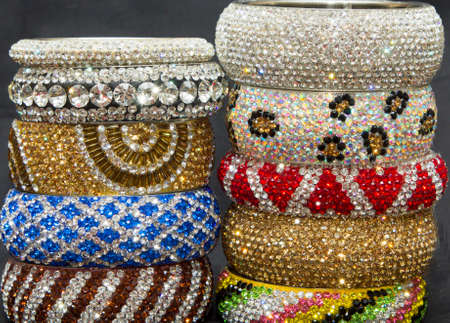 Crystal diamond stone metal bangles arranged in a pile