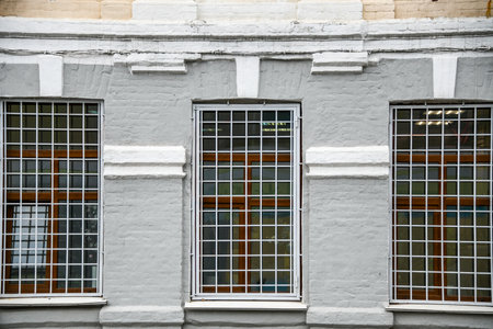 Window with bars on the facade of a building.の写真素材