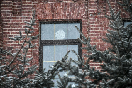 The window of an old brick building in the snow. Winter.の写真素材