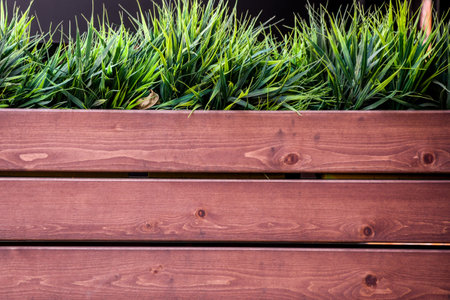 Wooden fence with grass. Wooden fence with green grass in the garden.の写真素材