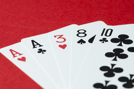 The combination of playing cards in poker on a red backgroundの写真素材