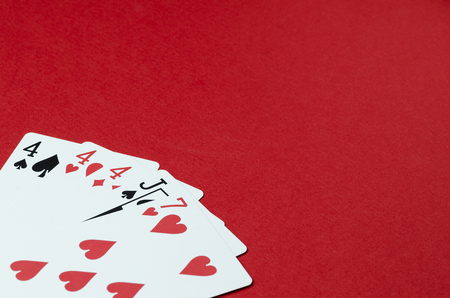 Playing cards, poker card combination. Red background, empty space for text