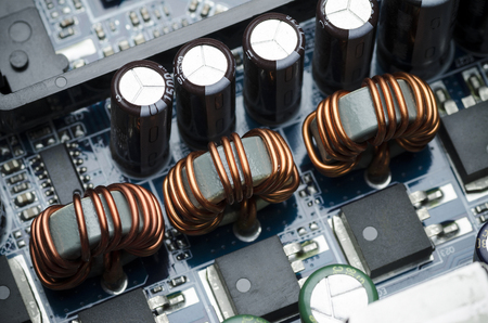 Ferrite rings with copper wire on electric boardの写真素材