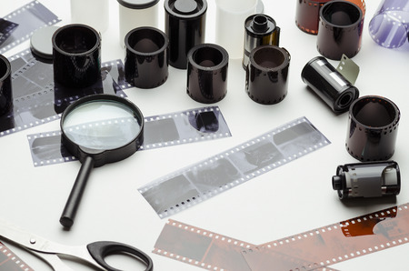 Film, scissors and magnifying glass on white backgroundの写真素材