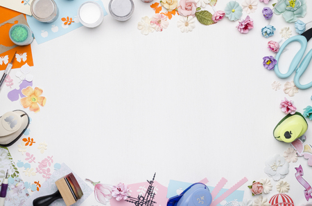 Empty white space in the center surrounded by paper flowers, multi-colored paper and scrapbooking materials. Top viewの写真素材