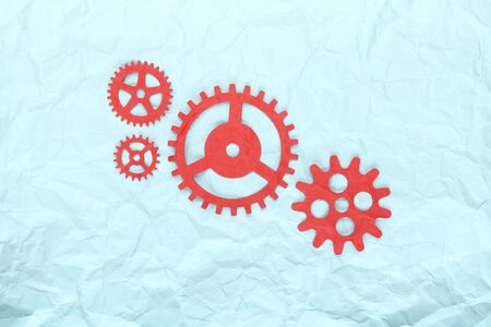 Crumpled paper and red paper gears in the center