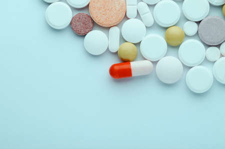 bright tablets of different shapes and colors on a blue background, close up