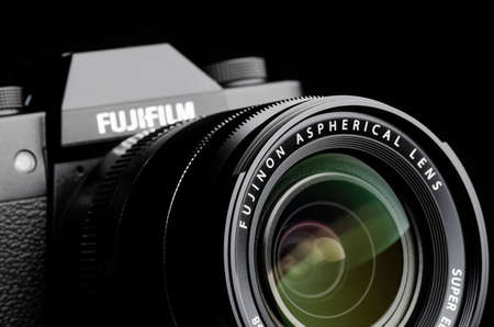Japan, Tokyo - March 9, 2020: Fujifilm camera with fujinon aspherical lens close-up on black backgroundのeditorial素材