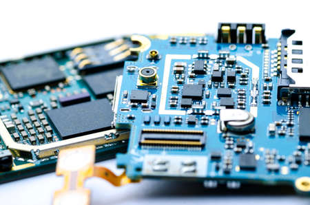 Disassembled electronic boards with chips, electronic components and precious metals for recycling, close-up, soft focusの写真素材