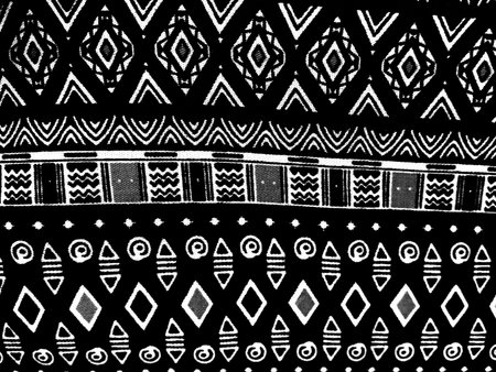 Black and white geometric textile pattern with symmetrical ethnic motifs and decorative woven design