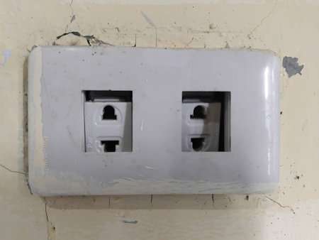 Close-up of a double electrical wall outlet installed on a wall, used for connecting household...