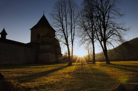 Sucevita monastery bathed in warm light at sunset