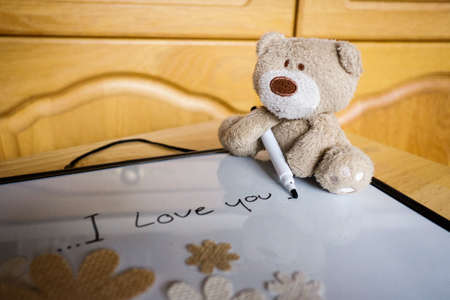 Mothers day greeting concepts with I love you Mom text and cute teddy,Top view on white board backgroundの写真素材