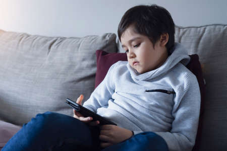 Kid self isolation using tablet for his homework,Child doing using digital tablet searching...