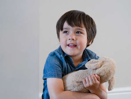 Portrait happy boy playing with dog toy on white background, Adorable Child with big smile playing...