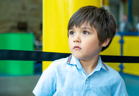 Candid shot kid looking up with chock face, Head shot child looking deep in through, Young boy with...