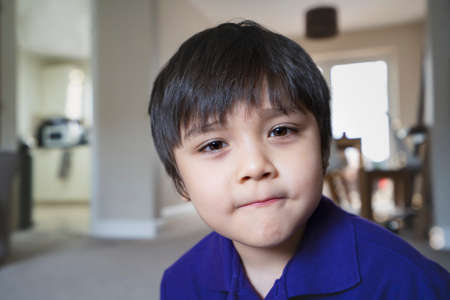 Close up. face kid looking at camera with smiling face, Snap shot healhty child relaxing at home,...