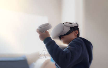 Amazed young kid wearing virtual reality goggles. Emotional Boy playing video games looking in VR...