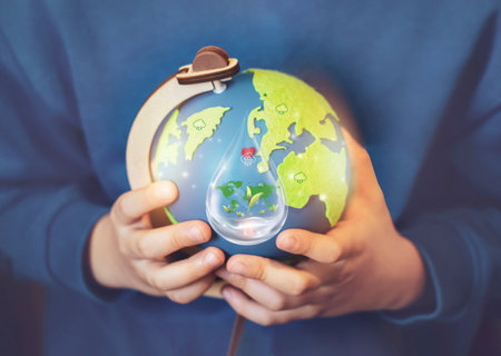 Hand  holding green world globe with tree growing on water, environment icon in rain drop, Save world, sustainable Reduce CO2 emission,Earth day on April 22,Green World environment day conceptの写真素材