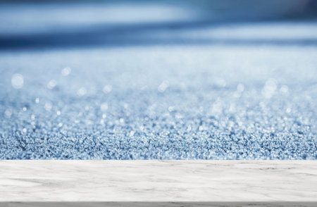 Marble top table on Defocus sunlight through frosty in winter,Glossy Marble shelf on bokeh reflection of Morning light,Granite floor texture background with Glitter for product display presentationの写真素材
