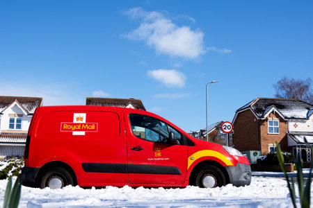 Middlesbrough, United Kingdom - March 10 2023,Royal Mail Car with snow covering on the on the road against clear blue sky on sunny day Winter,British Mail Delivery Vanのeditorial素材