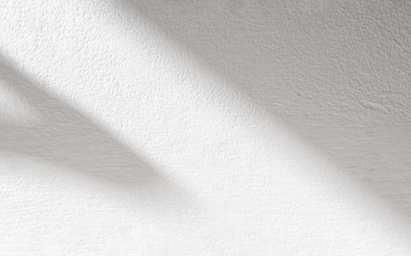 Cement texture wall with abstract shadow, sun light overlay on white plaster paint,Blank Plastering concrete wall painted with grey texture surface background,Exterior wall Backdrop for mockup presentationの写真素材