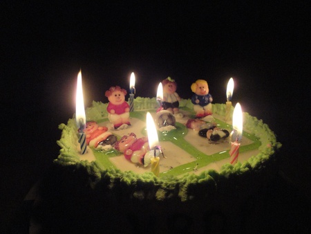 Birthday cake with football player doll in the darkの写真素材