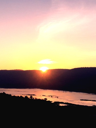 The rising sun at the mountain with a colorful skyの素材