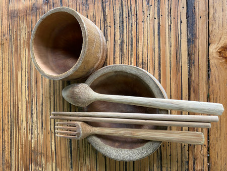 Wooden bowl, spoon and chopsticks on old wood background.の写真素材