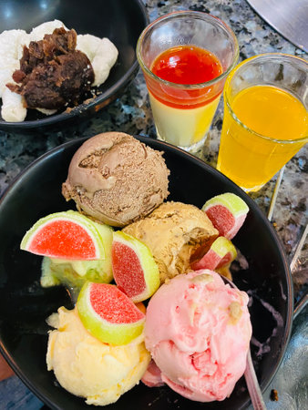 ice cream with fruits and juice in a plate on the table.の写真素材