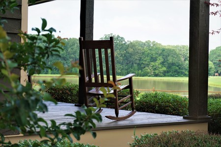 The wooden rocking chair at the beautiful view terrace is waiting for someone to relax on. GA USAの写真素材