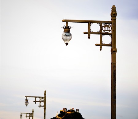 The beautiful elegance lamp on the golden color pole with the blue sky white clouds on the back ground, Prachuab Khiri Khan Thailand.の写真素材