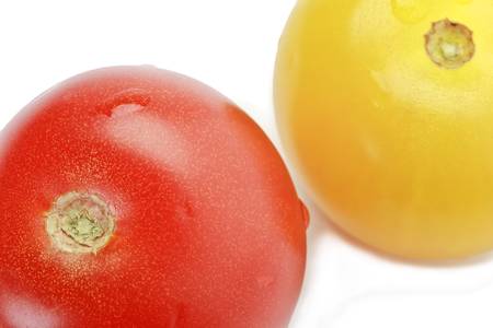 Fresh ripe red and yellow cocktail tomatoes isolated on whiteの写真素材