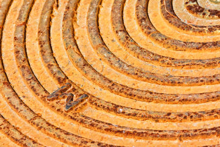 Close up of rusty grange city manhole cover detailの写真素材