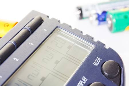 Accumulator battery charger with batteries on white background
