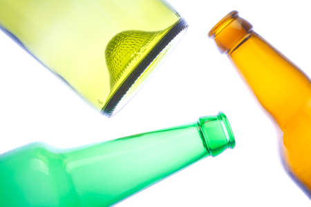 Empty wine and beer bottles on white background の写真素材