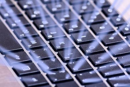 Laptop keyboard with magic blue backlight closeup