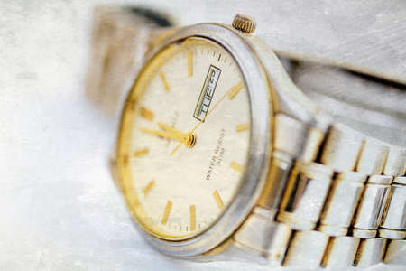 Old scratched wristwatch with metal wristletの写真素材