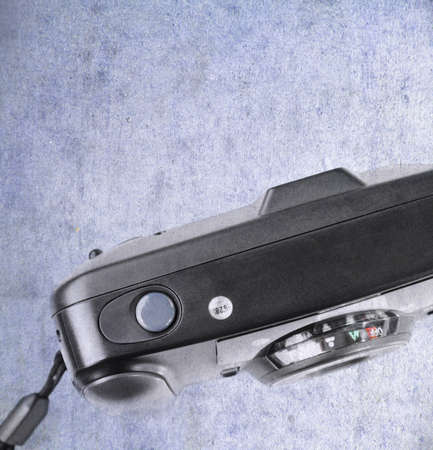 An old used film plastic camera over grunge backgroundの写真素材