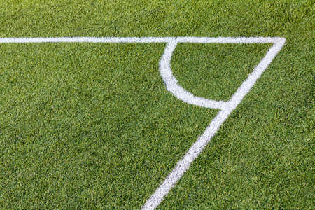 Football (soccer) artificial turf field corner with white marksの写真素材