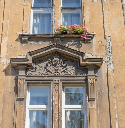 Face statue on front facade of old building.の写真素材