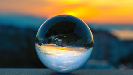 Playing with glass sphere. Catching sunrise in a sphere from my balcony in Rijekaの写真素材