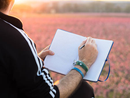 Hand of boy drawing in the fieldの写真素材