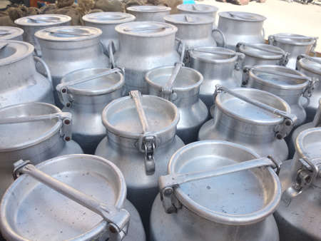Old aluminum milk jugs to contain the milk of the dairyの写真素材
