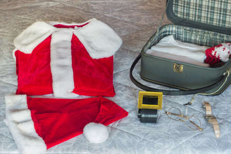 Preparing Santa's suitcase with his travel clothes. Selective approach. Concept of Christmasの写真素材