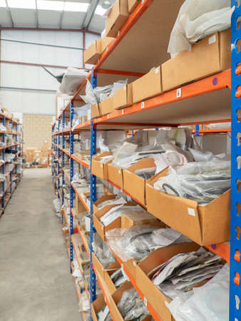 Shelves in a warehouse filled with material in small cardboard containers with material. Warehouse concept.の写真素材