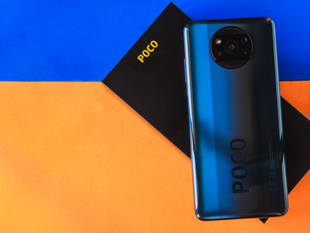 Lleida, Spain. 11/25/2020: Xiaomi POCO X3 blue new smartphone with black box close up developed by Xiaomi Inc. Xiaomi is a privately owned Chinese electronics company.のeditorial素材