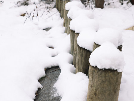 Fabulous winter landscape with fresh snow on rural wooden fenceの写真素材