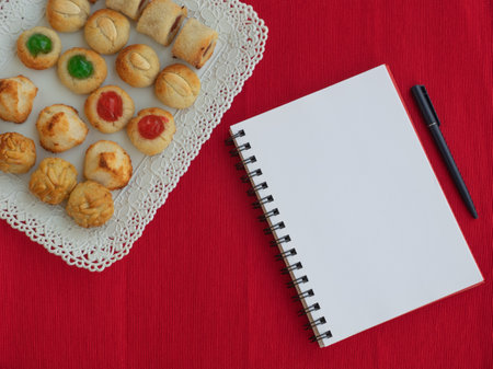 Homemade sweet panellets dessert, a typical pastry from Catalonia, Spain, on the All Saints festival. Notepad and pen for copy space. Food concept.の写真素材