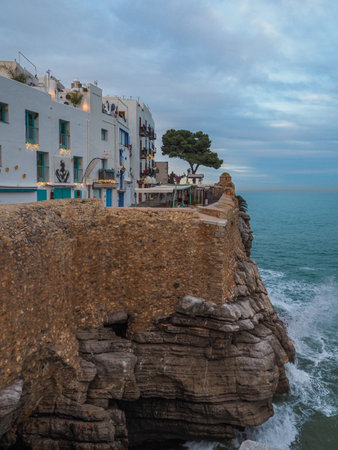 Nice view of a street of white houses in the town of Peniscola, Spain, on the cliff by the sea.の写真素材
